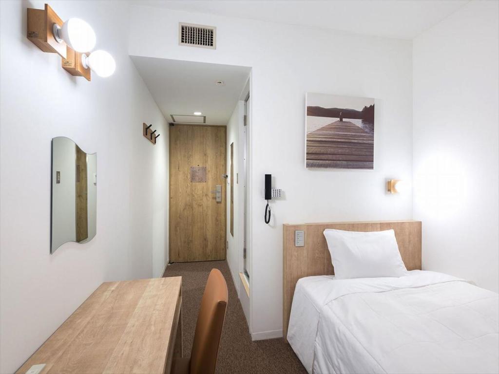 Postel nebo postele na pokoji v ubytování Hotel Plumm