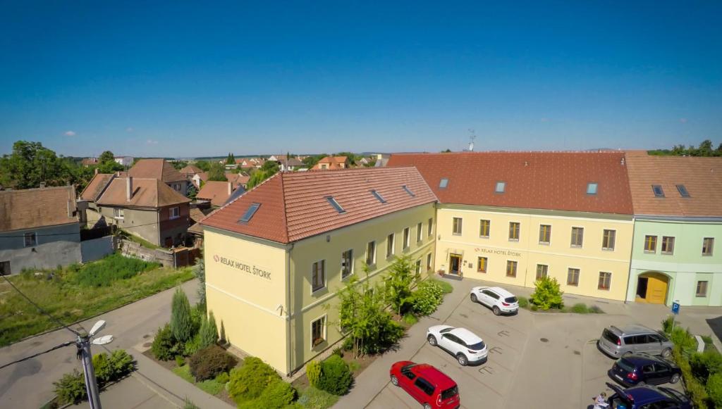 a large building with cars parked in a parking lot at Relax Hotel Stork in Lednice