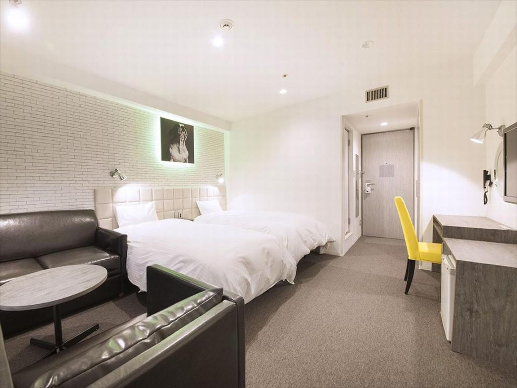 Postel nebo postele na pokoji v ubytování Hotel Plumm