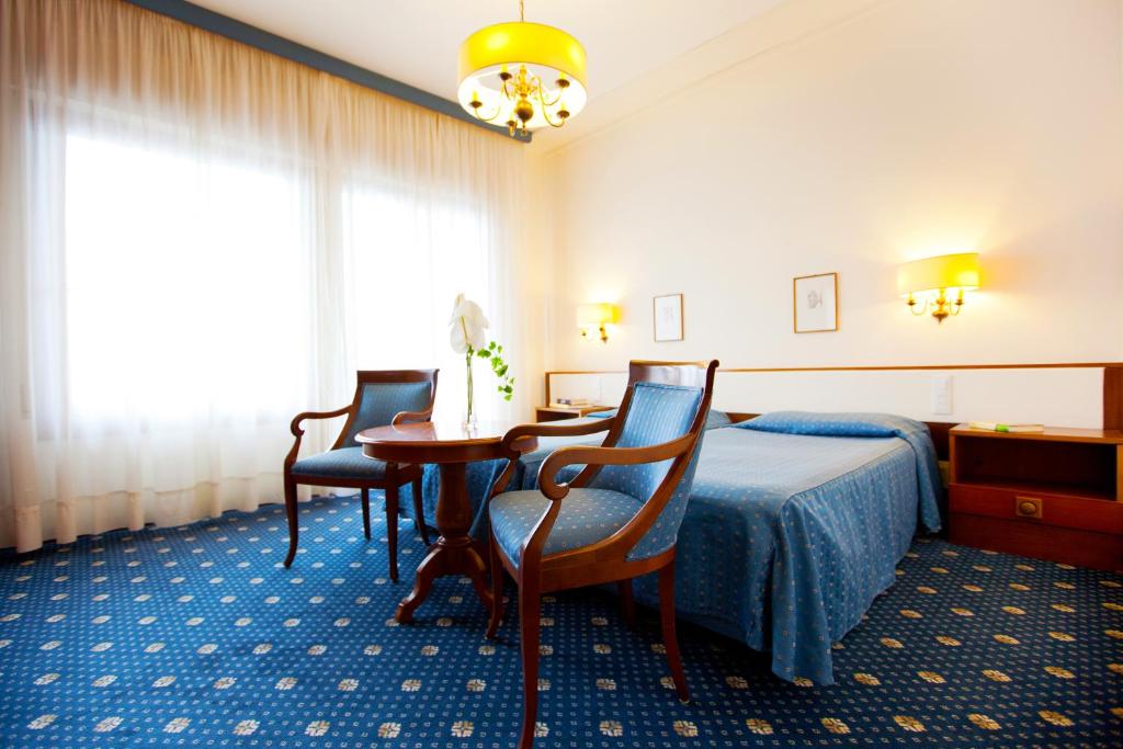 Postel nebo postele na pokoji v ubytování Hotel La Residence & Idrokinesis