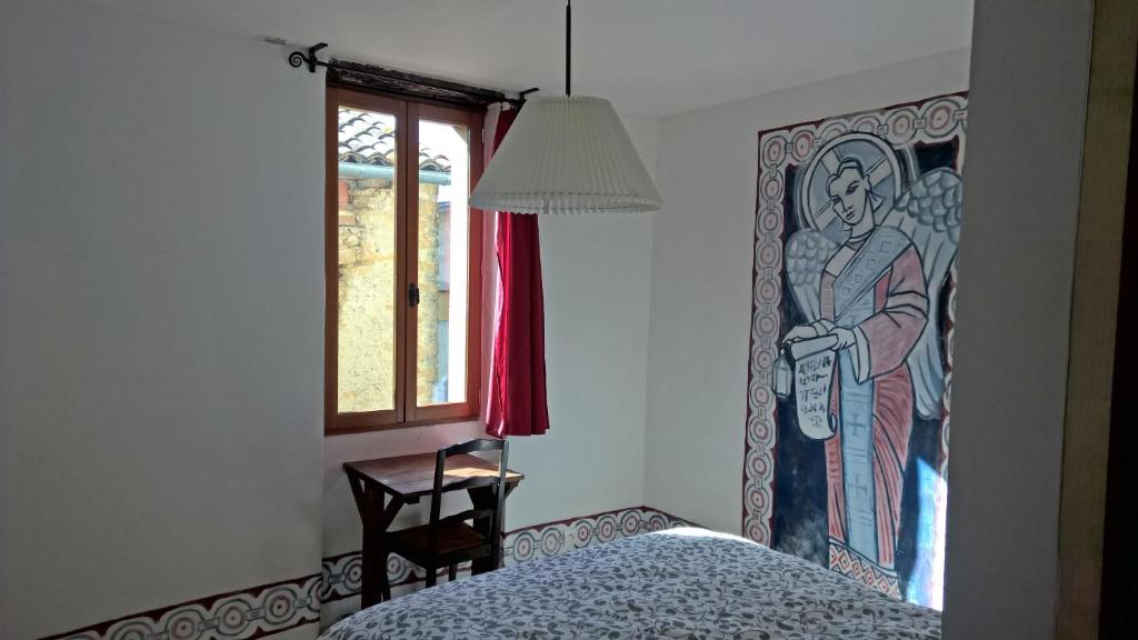 a bedroom with a painting on the wall next to a bed at Cafe Vals in Vals