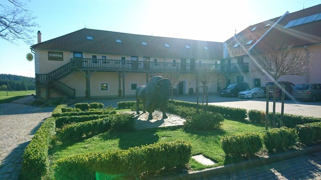a statue of a horse in front of a building at Bison Ranch in Rožnov