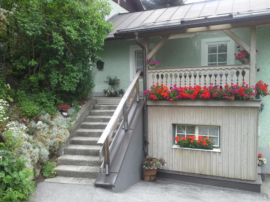 a house with a balcony with flowers on it at Ferienhaus Forsthof in Taxenbach