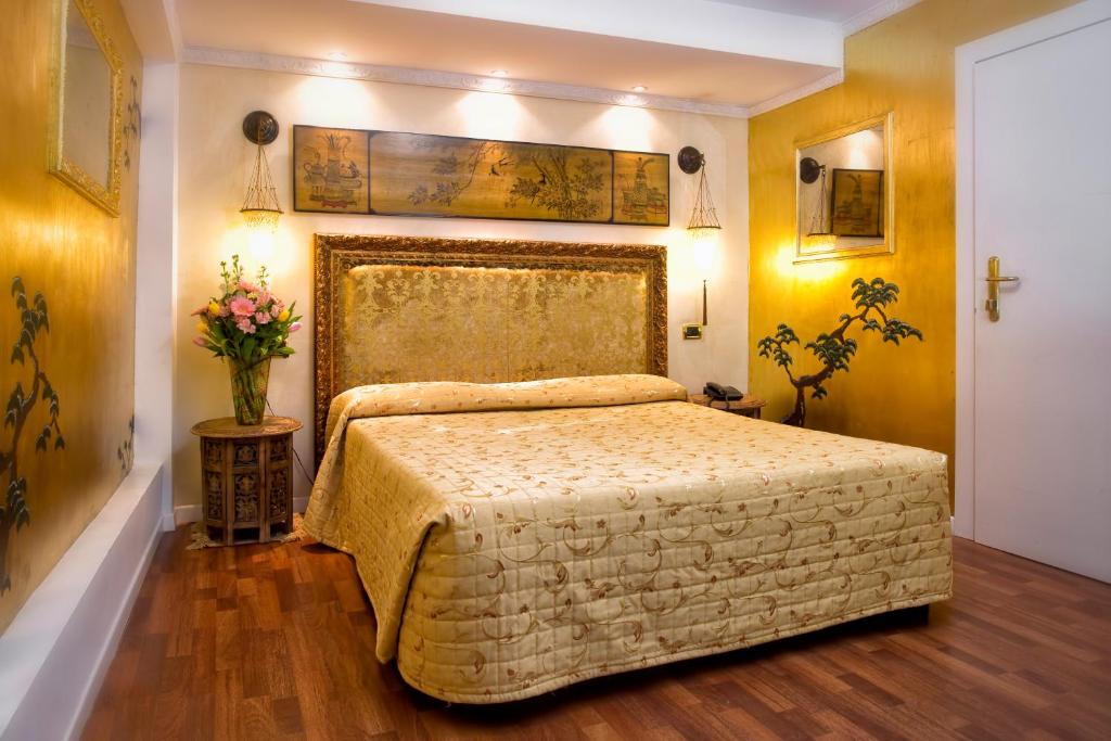 Postel nebo postele na pokoji v ubytování Hotel Noemi