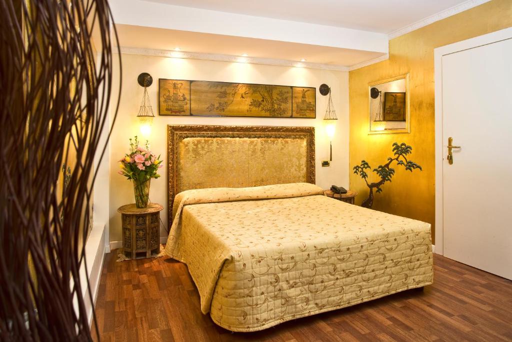 Postel nebo postele na pokoji v ubytování Hotel Noemi