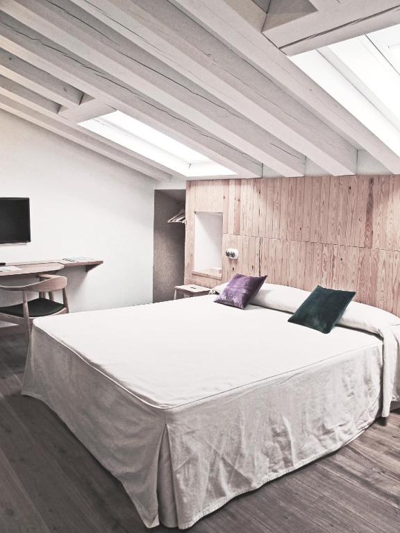 Postel nebo postele na pokoji v ubytování Hotel Ayllon