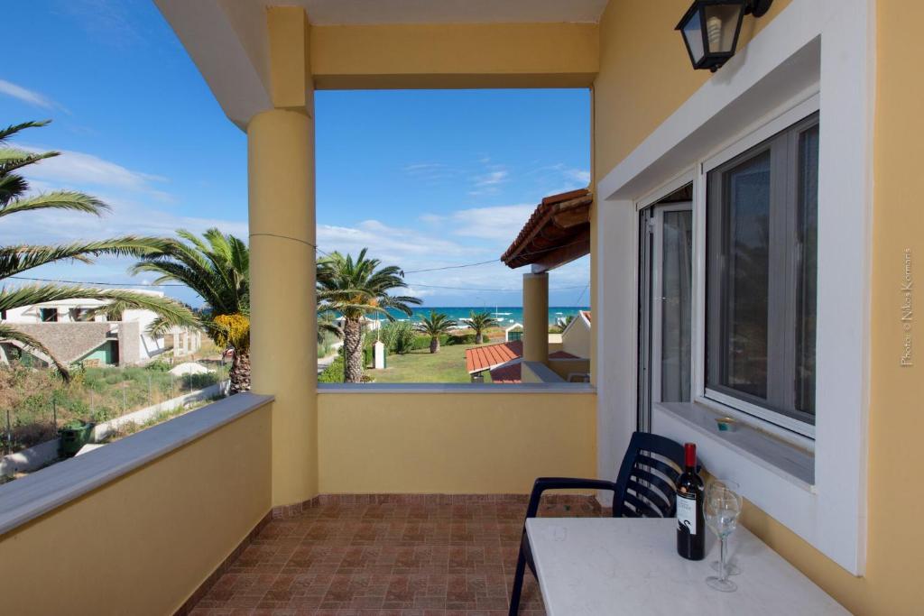 a balcony with a table and a view of the ocean at Residence Vista Del Mare in Acharavi