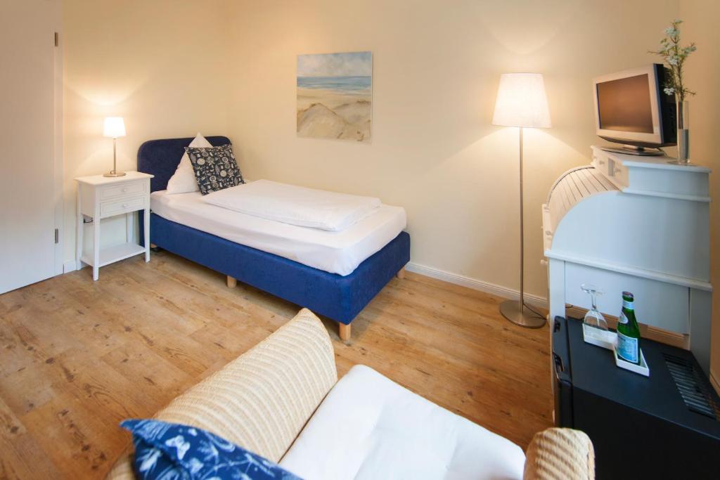Postel nebo postele na pokoji v ubytování Das Frühstückshotel Sankt Peter-Ording