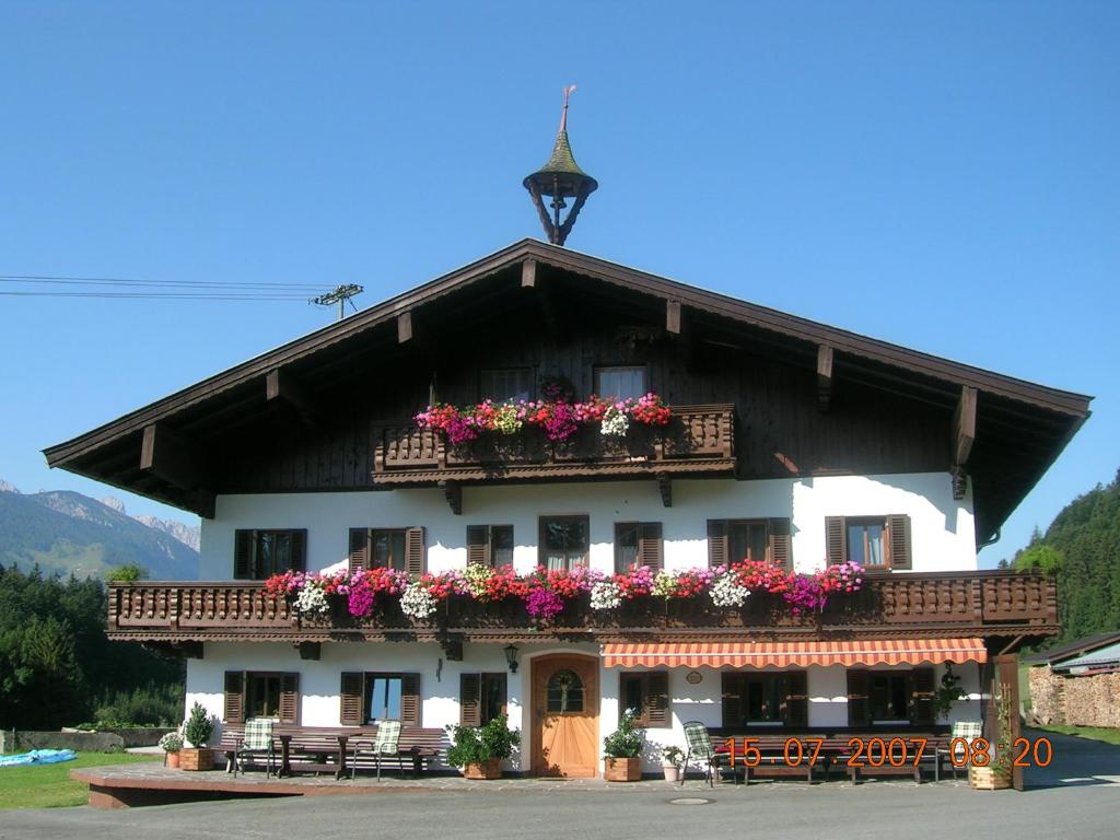 a building with flower boxes on the front of it at Riedlhof in Kössen