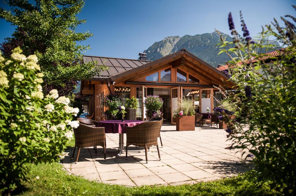 a house with a table and chairs on a patio at Chalet Oberstdorf in Oberstdorf