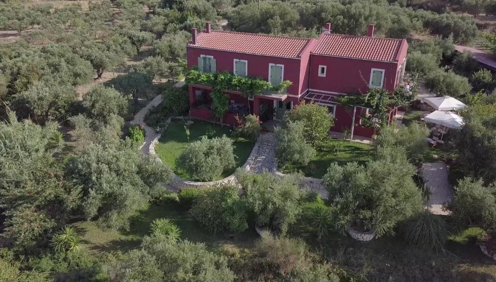 an aerial view of a red house with trees at Volidiera Guesthouse in Lixouri