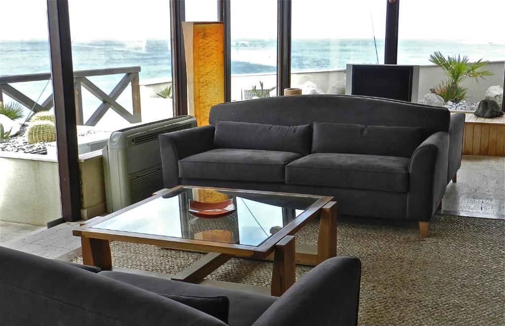 a living room with a couch and a coffee table at Hotel Capo San Vito by Geocharme in San Vito lo Capo