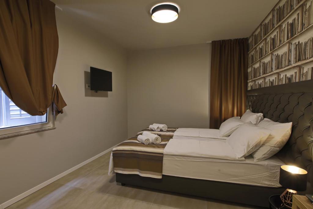 Posteľ alebo postele v izbe v ubytovaní Spalato Luxury Rooms