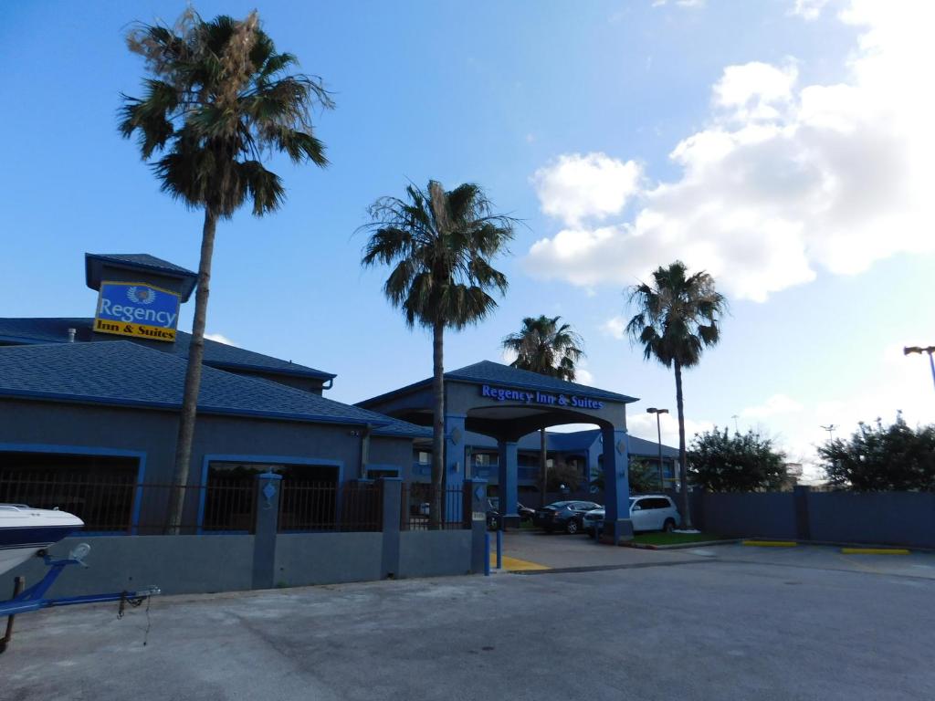 a gas station with palm trees in a parking lot at Regency Inn & Suites Beaumont in Beaumont