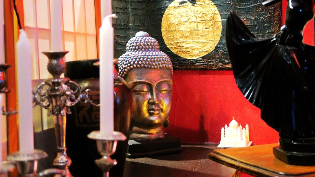 a statue of a head on a table with two candles at New Norfolk Junction Motel in New Norfolk