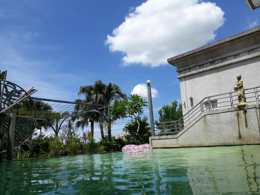 a man standing on the ledge of a pool of water at Light and Shadow B&amp;B in Yuanshan