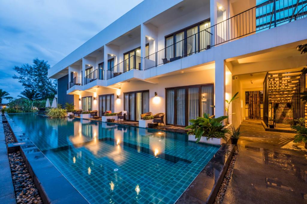 an image of a swimming pool in front of a building at Ren Resort in Sihanoukville