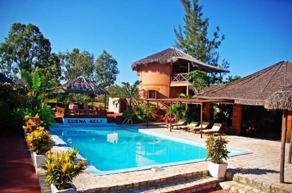 a swimming pool in front of a house at Edena Kely in Mahajanga