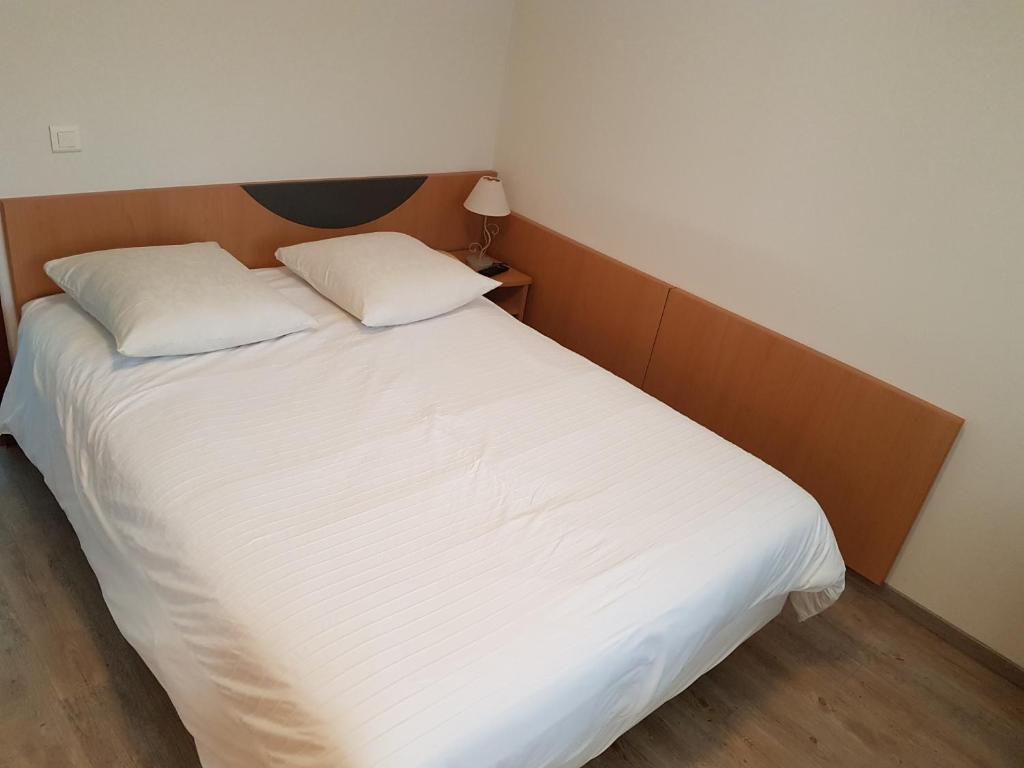 Postel nebo postele na pokoji v ubytování Hôtel Des Bois
