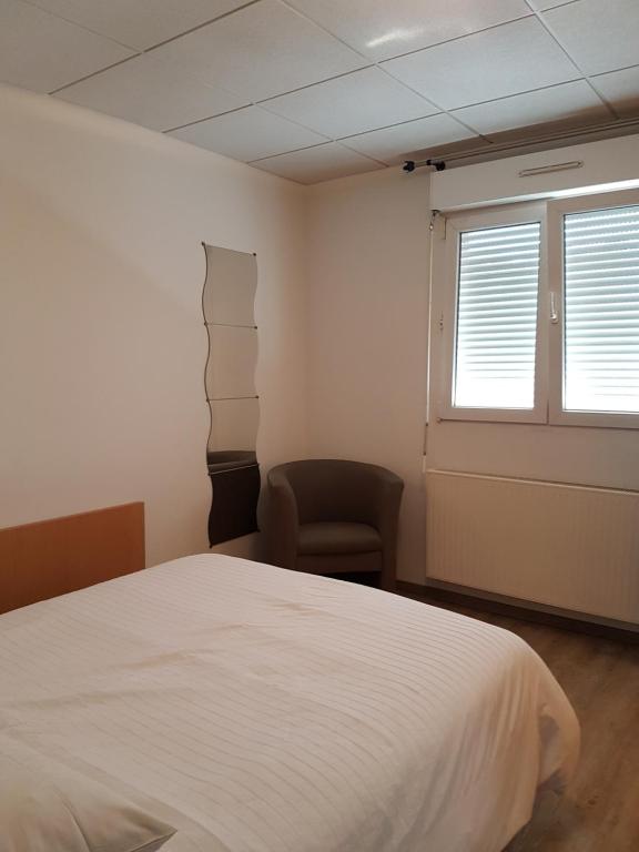 Postel nebo postele na pokoji v ubytování Hôtel Des Bois