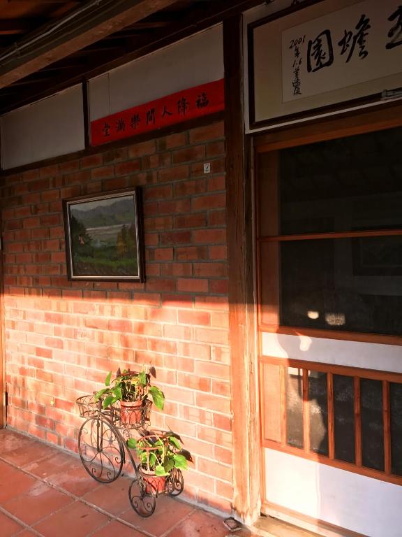 a plant in a pot next to a brick building at 玉蟾園民宿 寵物友善 YuChanYuan B&amp;B in Chishang