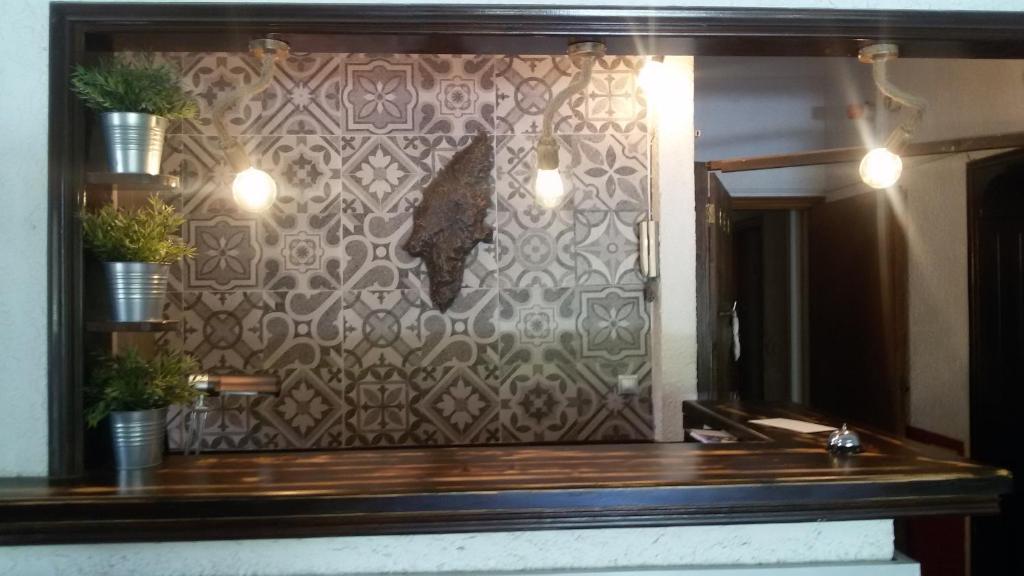 a bathroom with a sink and a wall with a mirror at Emmanuel Apartments in Rhodes Town