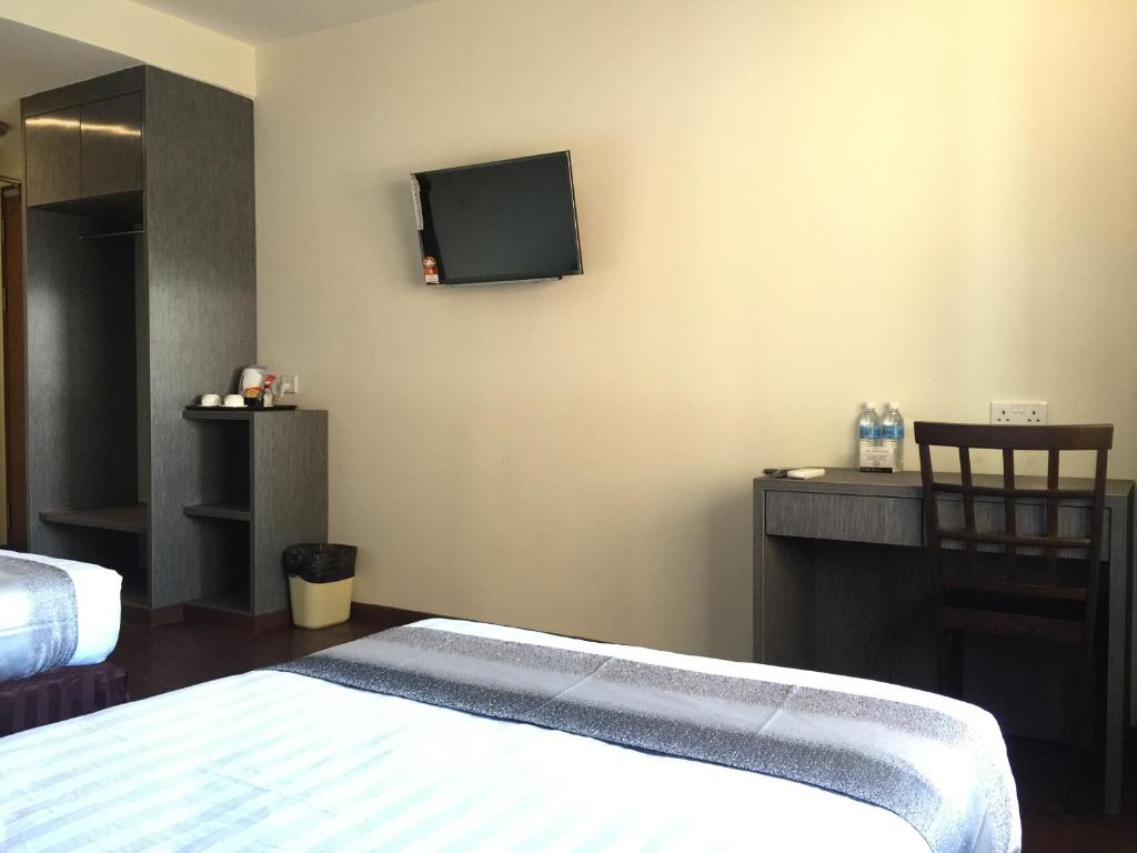 Postel nebo postele na pokoji v ubytování Check Inn Hotel Tawau