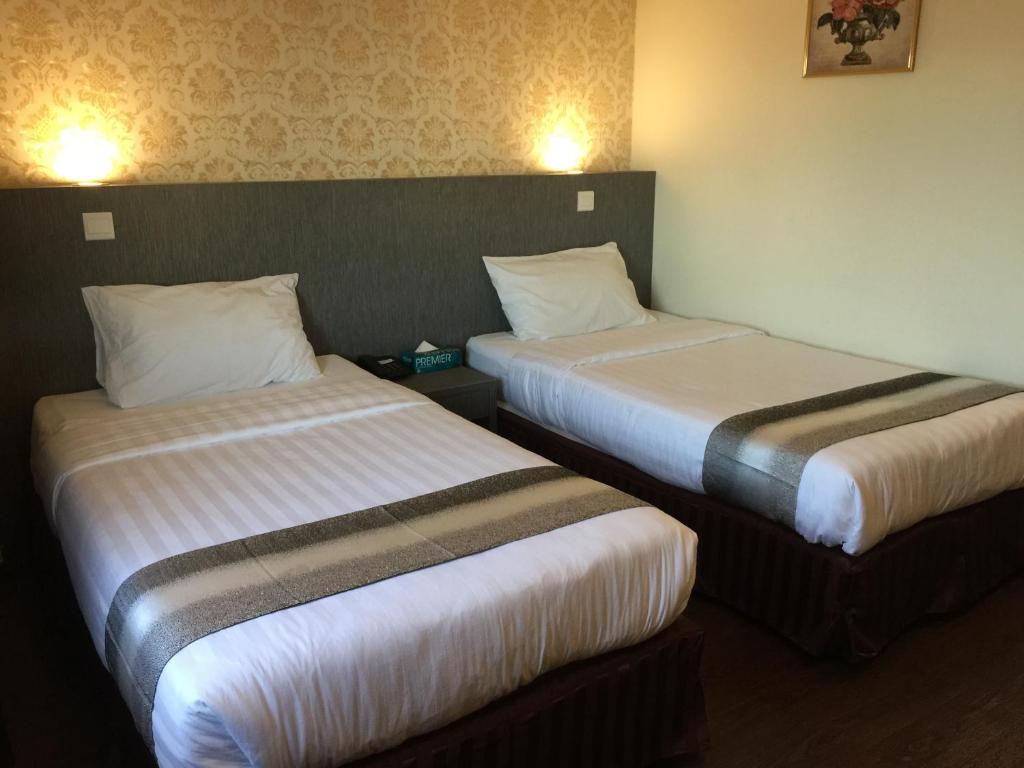 Postel nebo postele na pokoji v ubytování Check Inn Hotel Tawau
