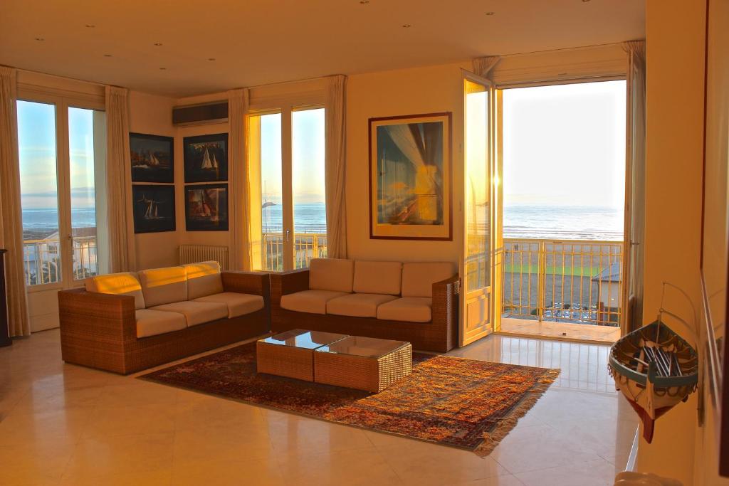 a living room with a couch and a table at Attico Sul Mare in Lido di Camaiore