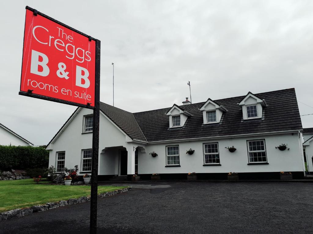 a sign in front of a building with a house at The Creggs in Ballyvaughan
