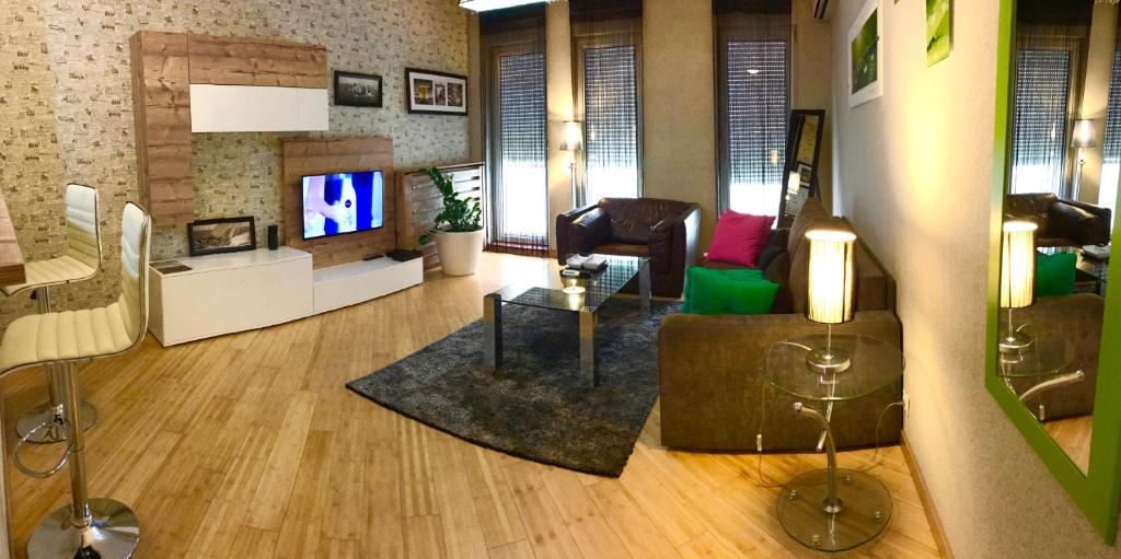 a living room with a couch and a tv at Vip apartment Beograd in Belgrade