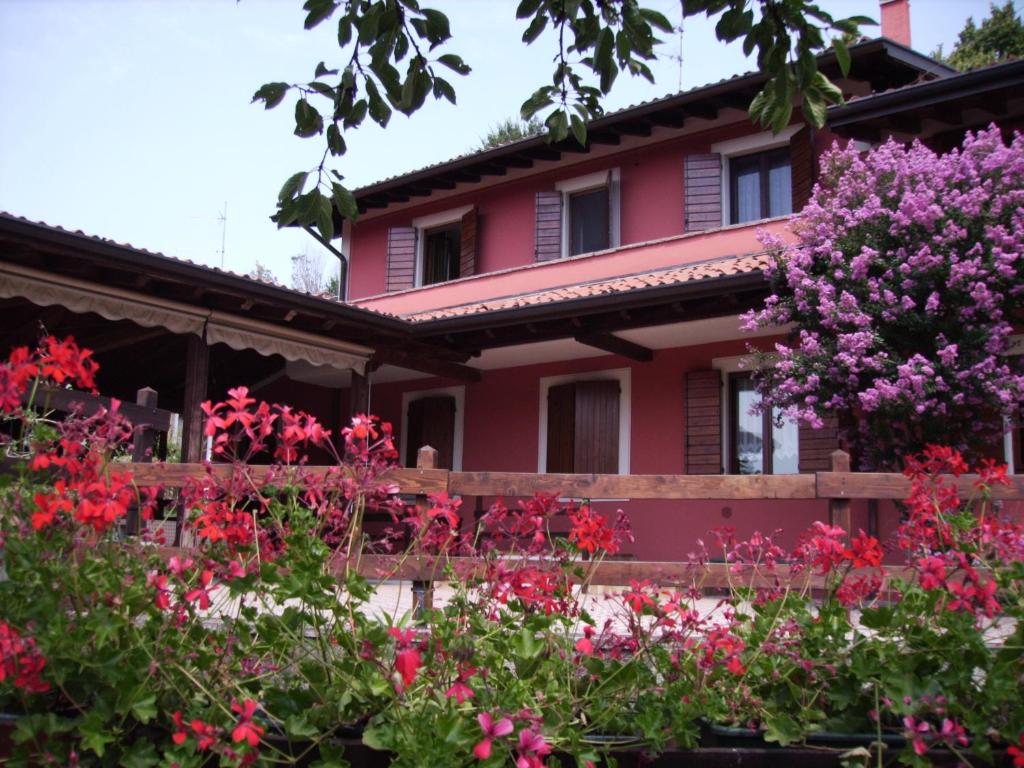 a house with flowers in front of it at L' Arnia in Ome