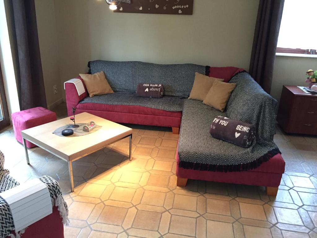 a living room with a couch and a table at Le Valdine in Jemeppe