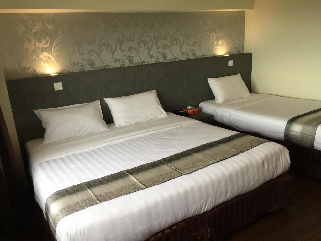 Postel nebo postele na pokoji v ubytování Check Inn Hotel Tawau