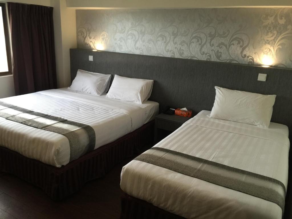Postel nebo postele na pokoji v ubytování Check Inn Hotel Tawau