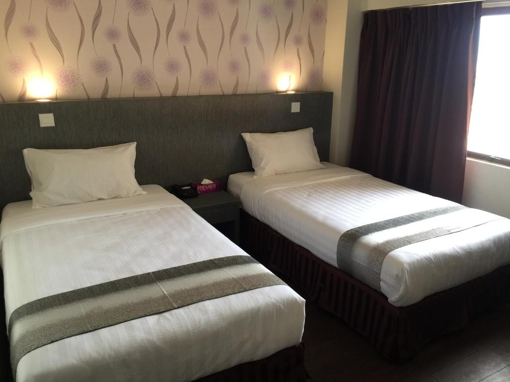 Postel nebo postele na pokoji v ubytování Check Inn Hotel Tawau