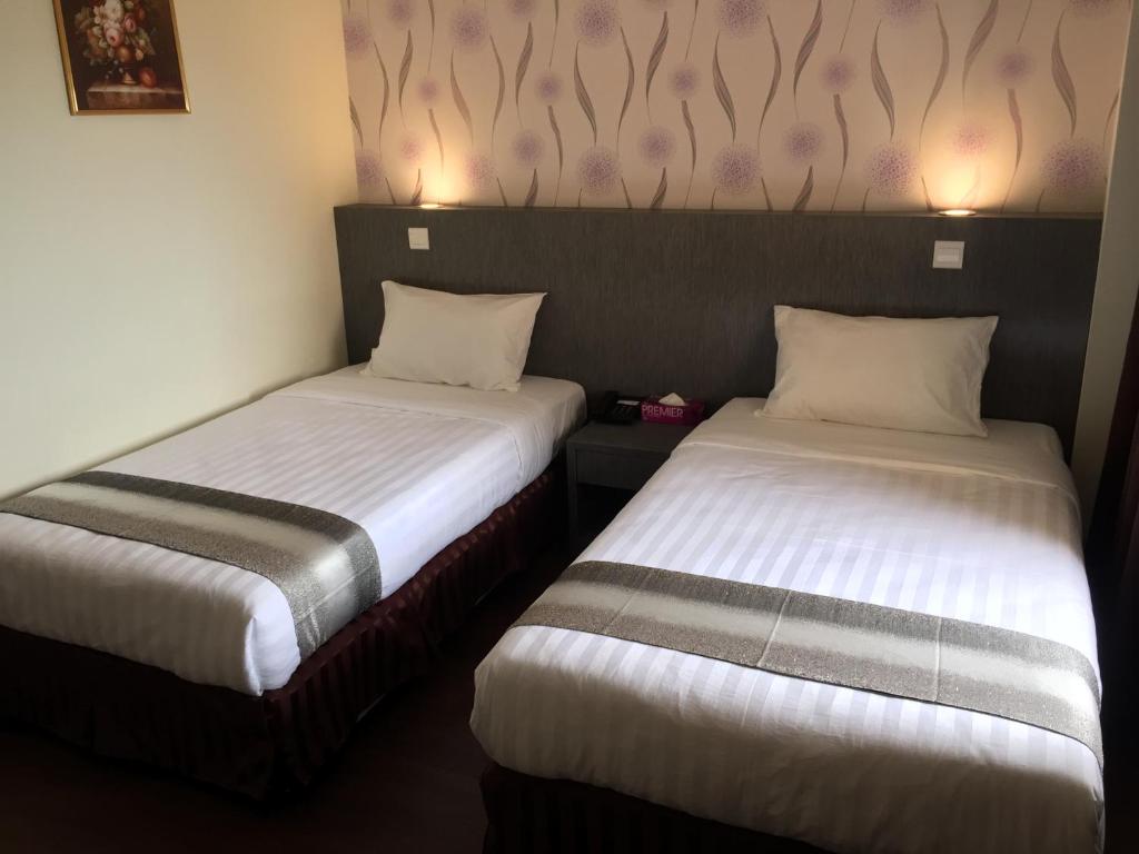 Postel nebo postele na pokoji v ubytování Check Inn Hotel Tawau