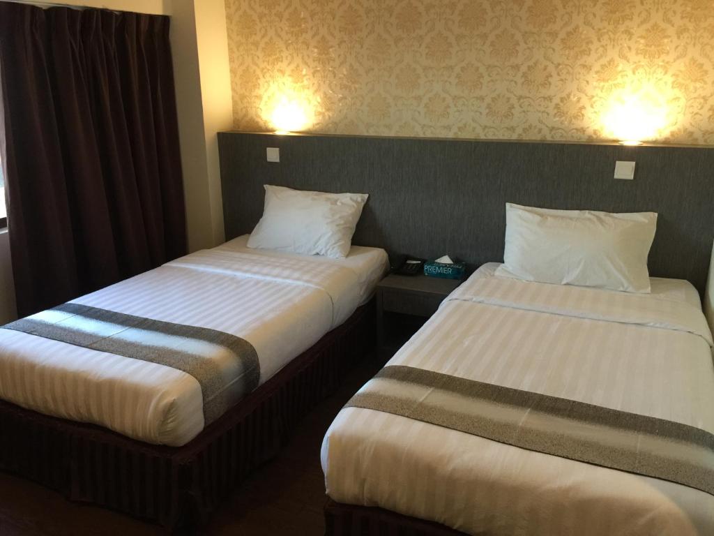 Postel nebo postele na pokoji v ubytování Check Inn Hotel Tawau