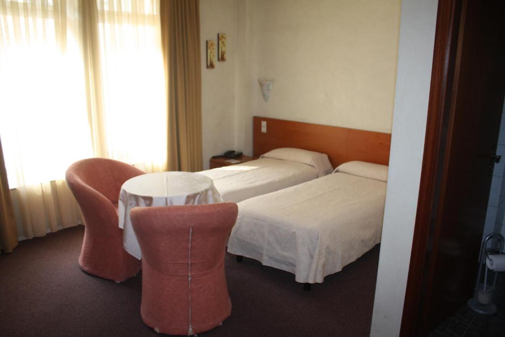 Postel nebo postele na pokoji v ubytování Auberge Gaglioti