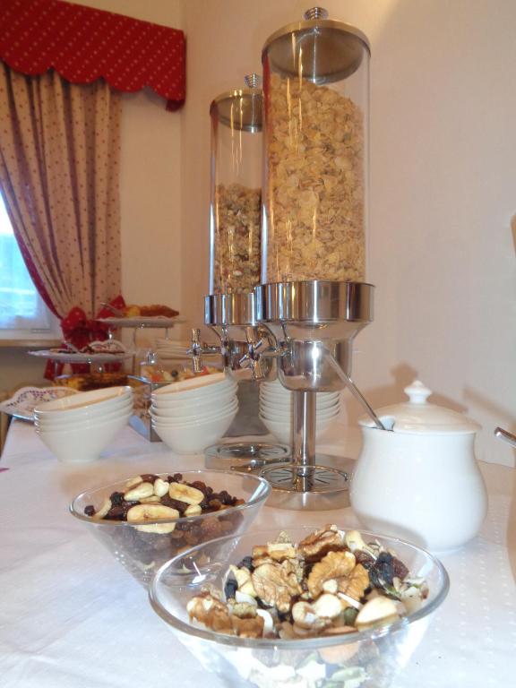 a table with two plates of food on a table at Hotel Garni Suisse in San Martino di Castrozza
