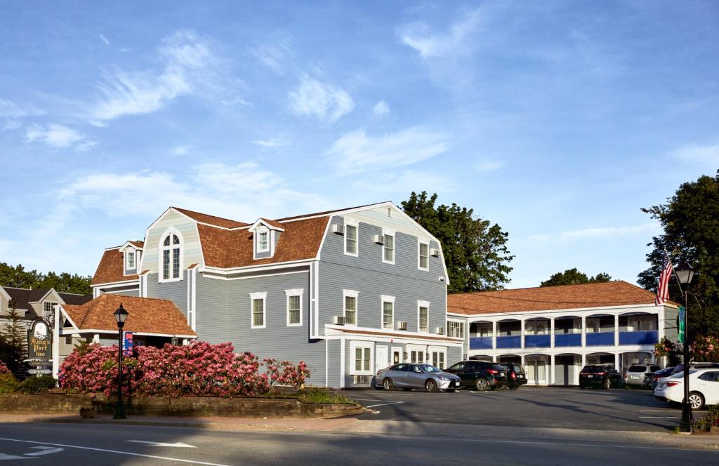 a large white building with a blue roof at King's Port Inn in Kennebunkport