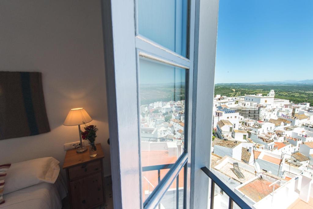 a room with a view of a city from a window at La Botica de Vejer in Vejer de la Frontera