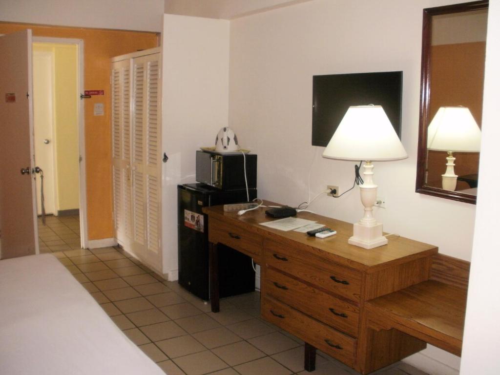 Postel nebo postele na pokoji v ubytování Pineapple Court Hotel