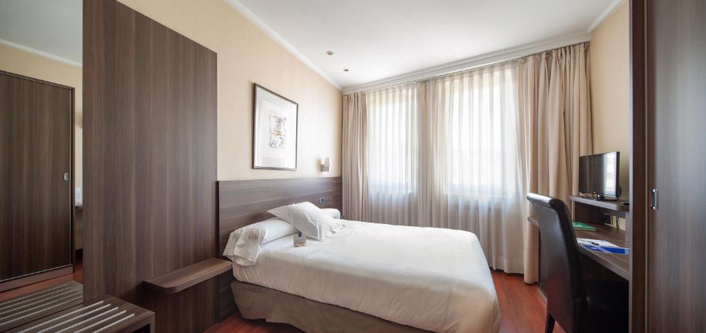 Postel nebo postele na pokoji v ubytování Hotel Yoldi