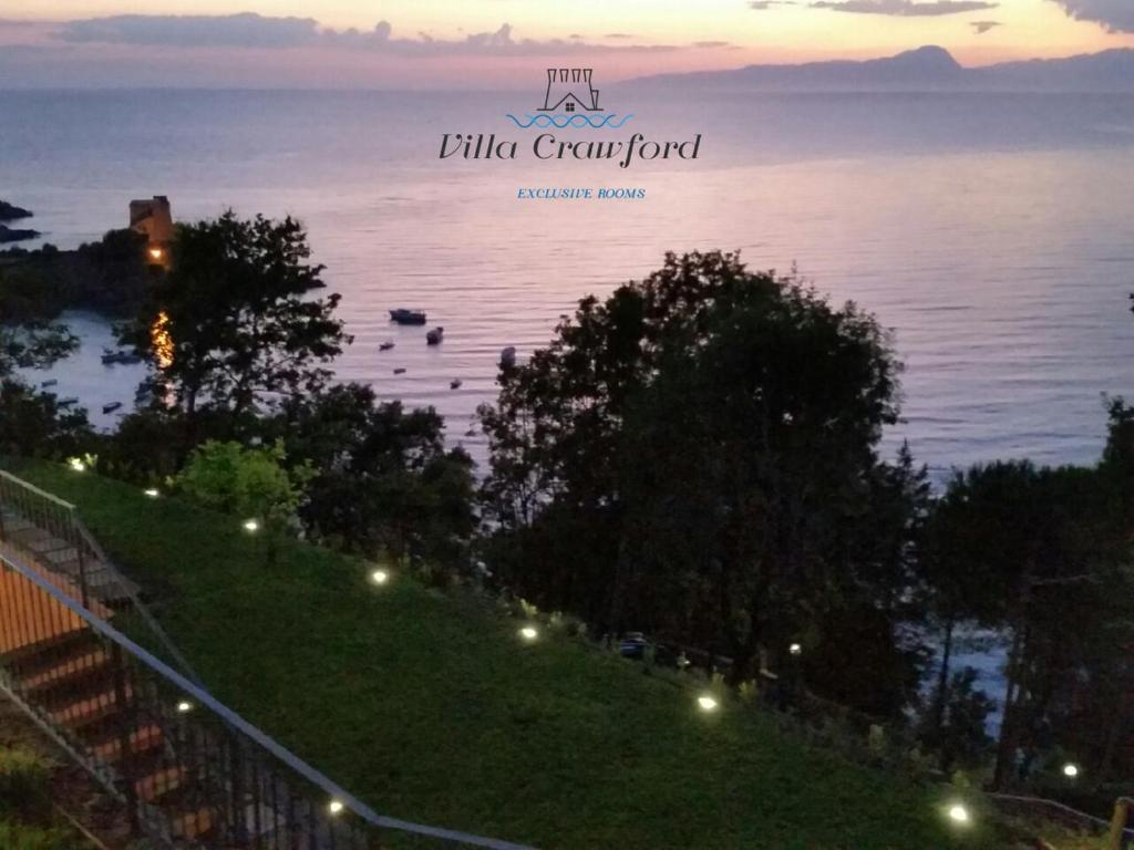 a view of the ocean with boats in the water at Villa Crawford in San Nicola Arcella
