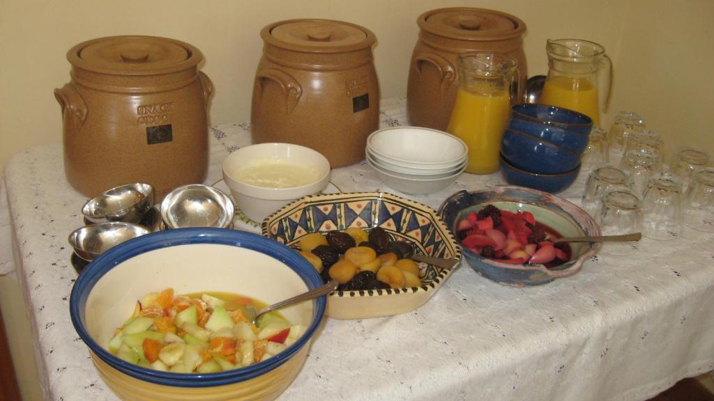 a table with bowls of fruit and jars of juice at An Bruachan B&B in Kenmare