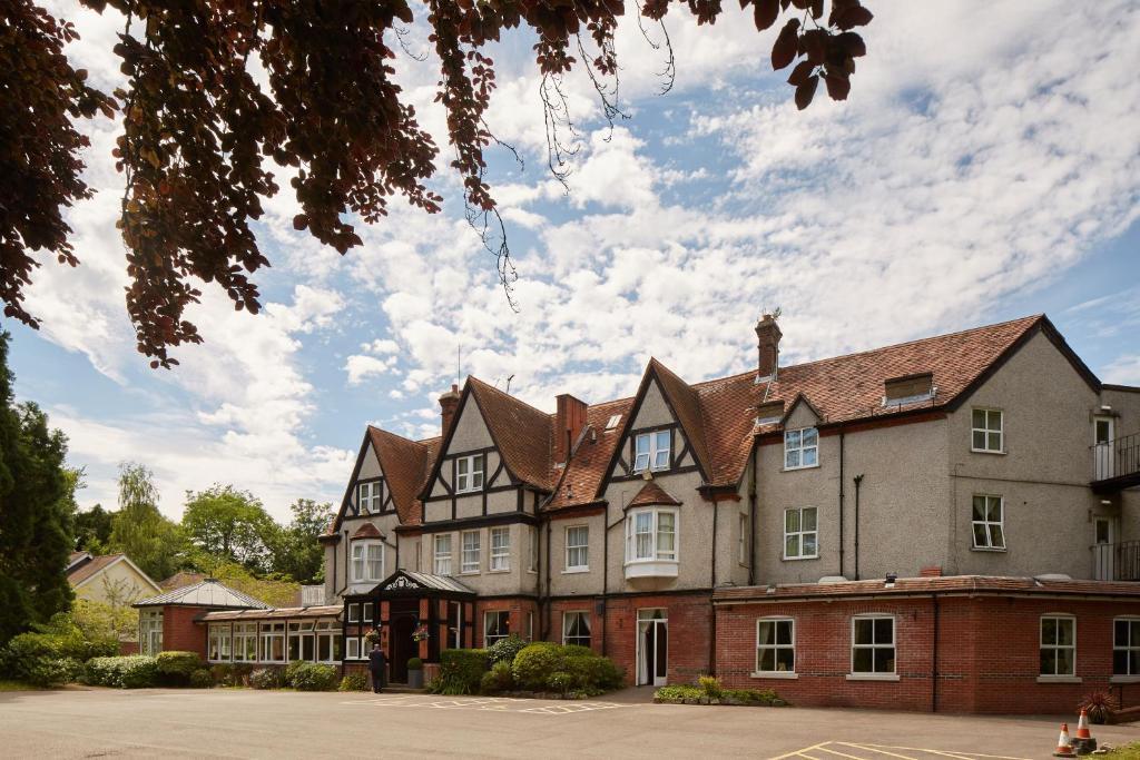 a large brick building with a sky at Lismoyne Hotel in Fleet