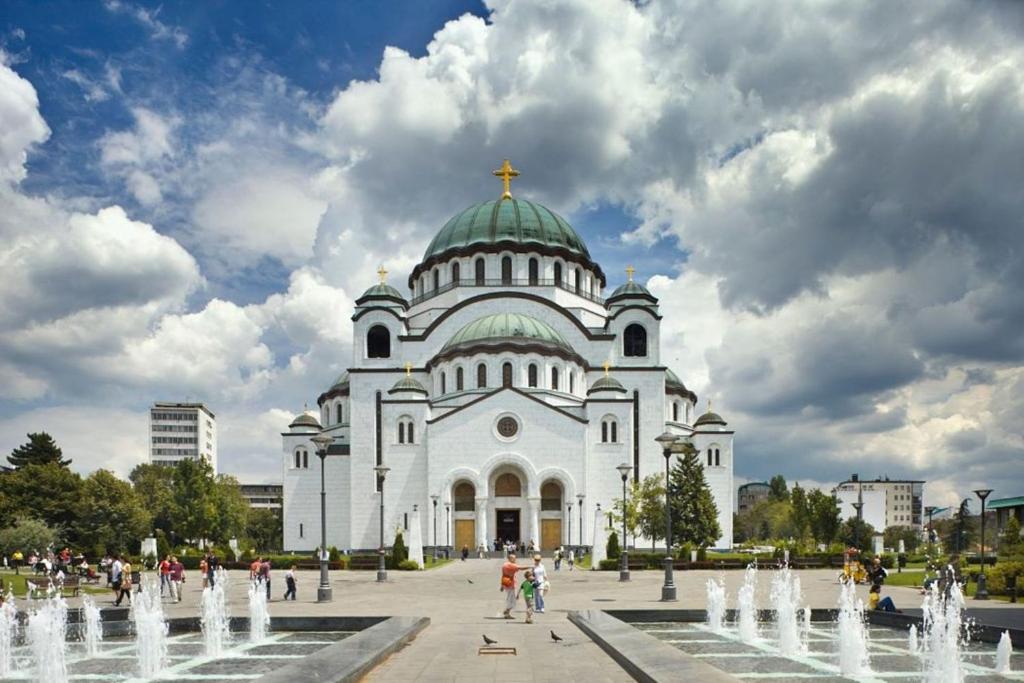 a large white church with a cross on the top at Manjež Centar in Belgrade