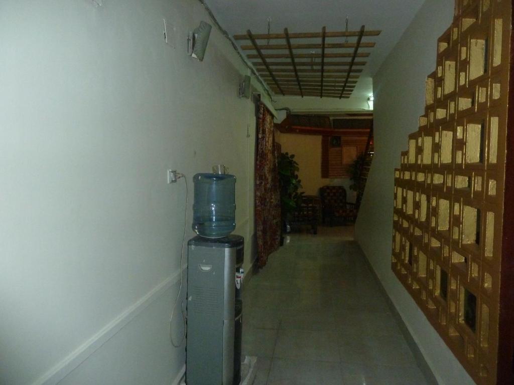 a hallway with a water heater in a room at Venus Hostel in Cairo