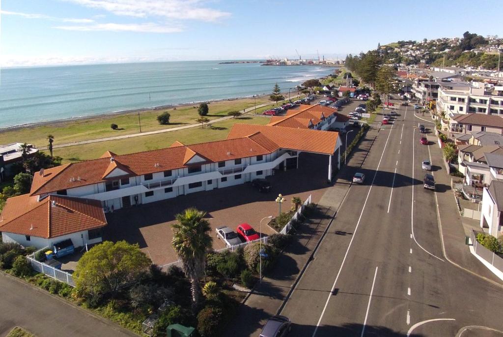 an aerial view of a town with a street and the ocean at Harbour View Seaside Accommodation Napier in Napier